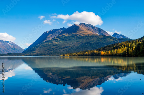 mountain and autumn foliage of trees reflection on a calm lake in the Kenai peninsula in Alaska. photo