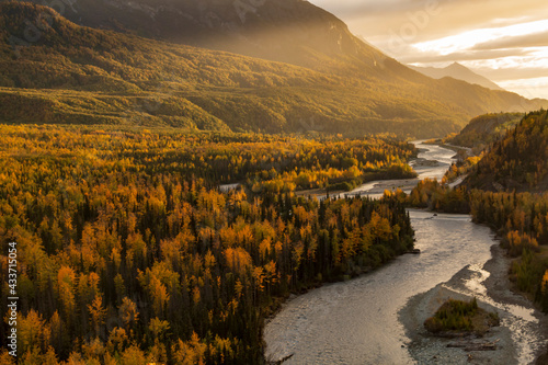 dramatic landscape of autumn foliage in the Matanuska River and snow capped mountains of the Chugach mountain range in Alaska photo