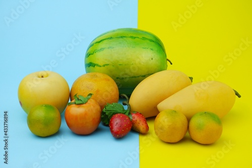 Plastic fruit on blue background with yellow color. Fake fruit  fruit model.
