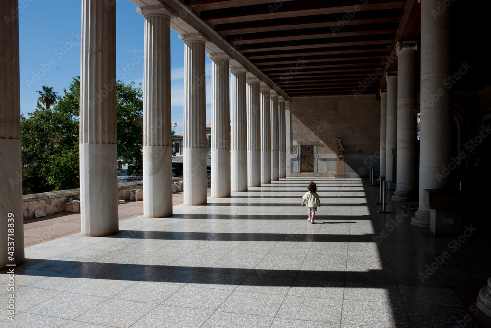 Athens, Greece / May 2021: A child at the archaeological site of the Ancient Agora of Athens without tourists due to Corona virus restrictions.	