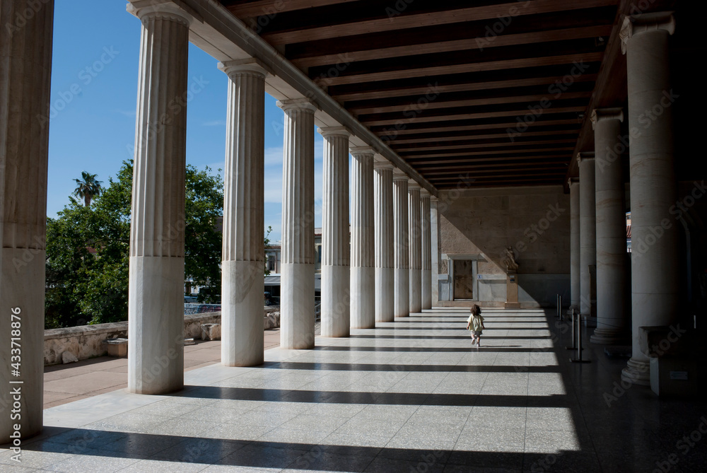 Athens, Greece / May 2021: A child at the archaeological site of the Ancient Agora of Athens without tourists due to Corona virus restrictions.	