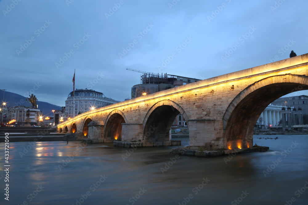 Stone Bridge at cloudy day in Skopje, Macedonia. Stone bridge is considered a symbol of Skopje. Stone Bridge at cloudy day in Skopje, Macedonia. Stone bridge is considered a symbol of Skopje.