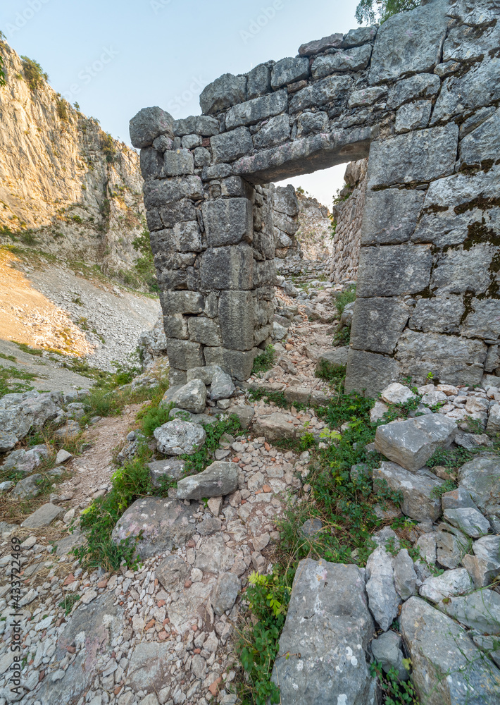 Ancient ruins near St John's church,surrounded by beautiful rocky mountain scenery at sunset, Kotor,Montenegro.