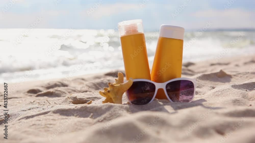 Sunscreens on the beach near the sea close up Sunscreens on the beach near the sea close up