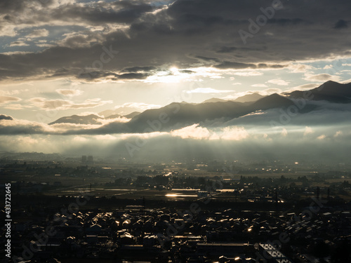 Scenic view of Matsumoto city with Northern Alps in the background at sunset, view from Joyama park observation tower - Nagano prefecture, Japan photo