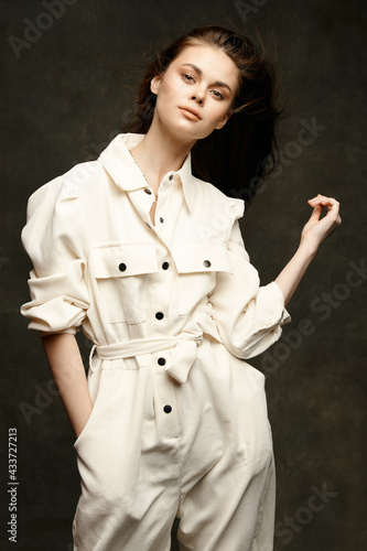 lady in jumpsuit on dark background hairstyle model cropped view