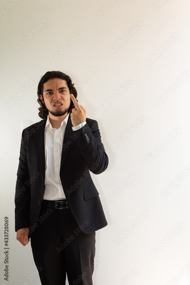 Hispanic man in black suit demonstrating a negative attitude on a white background