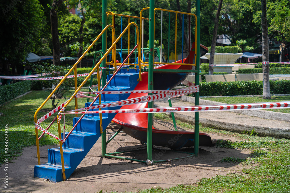 Park kids and children playground for game and activity empty and closed for Coronavirus or Covid19. And strips with word Park kids and children playground for game and activity empty and closed for Coronavirus or Covid19. And strips with word