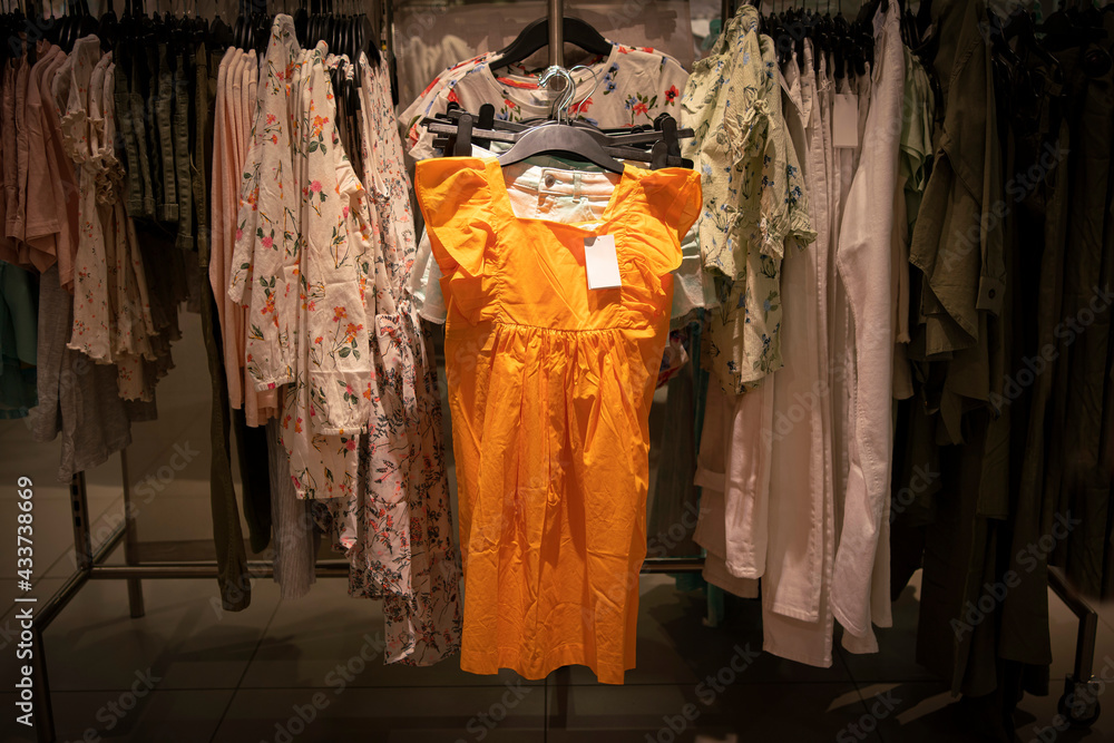 little orange dress in the window. Orange dress in the store. Summer Orange Dress