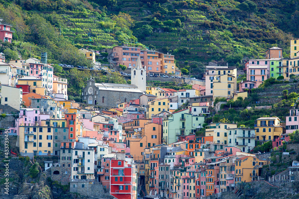 View on seaside and typical colorful houses in small village, Riomaggiore, Cinque Terre, Italy