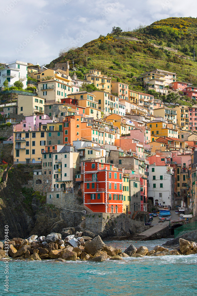 View on seaside and typical colorful houses in small village, Riomaggiore, Cinque Terre, Italy