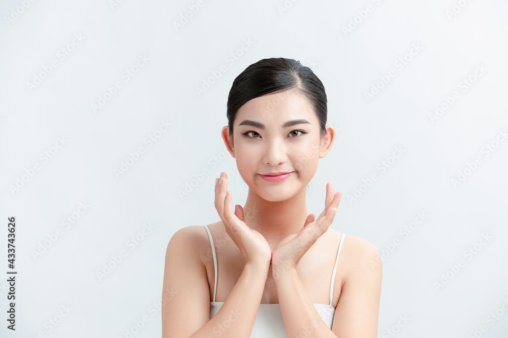 Beautiful young asian woman with clean fresh skin on white background Beautiful young asian woman with clean fresh skin on white background