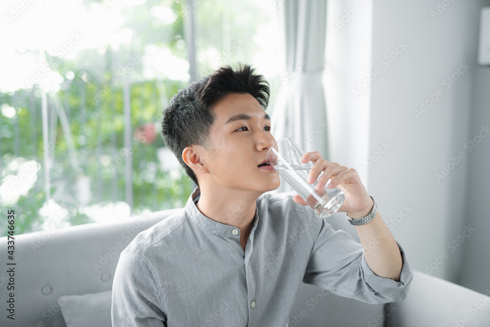 Handsome man drinking a fresh glass of water Handsome man drinking a fresh glass of water