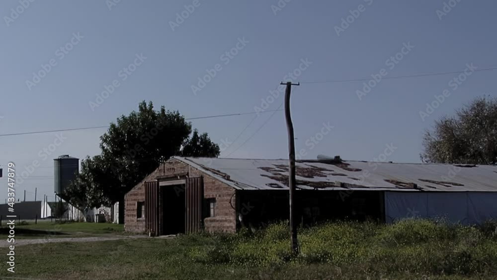 Farmer Garaging a Pickup Truck into a Rural Shed. Farmer Garaging a Pickup Truck into a Rural Shed.