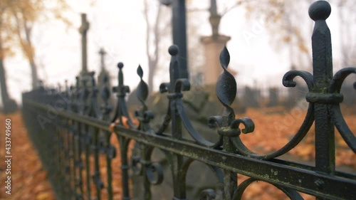 Fence with cobwebs in Autumn at the Bernardine XIX century cemetery