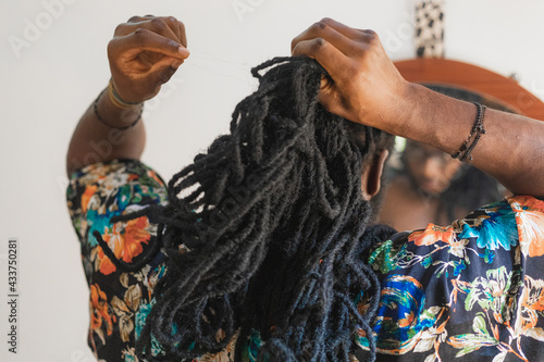Man dressing hair up.