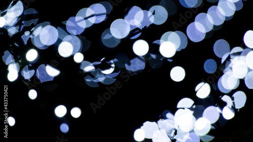 Abstract background of white and blue light halos or circles in a tree