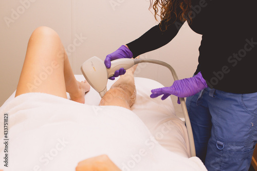 Nurse performing laser hair removal