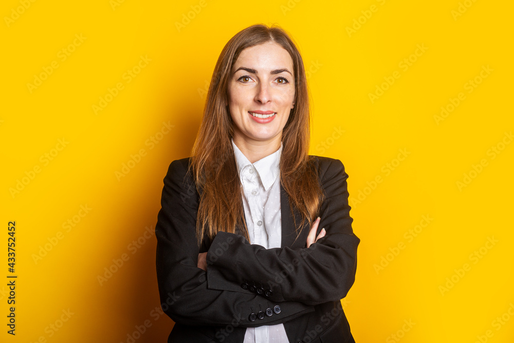 smiling young business woman in a black jacket on a yellow background smiling young business woman in a black jacket on a yellow background