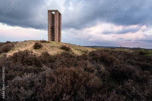 Remains of world war 2 tower with moody clouds © Joel