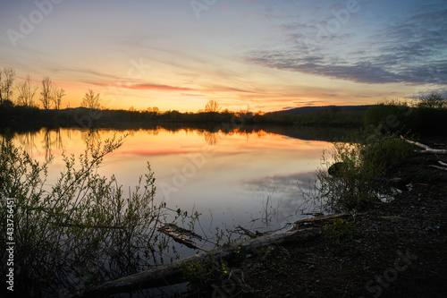 Beautiful Sunset Scenery on small lake with reflection of the sky