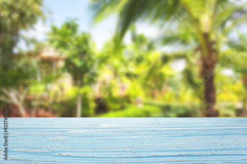 Blue wood table top on blur tropical plants background