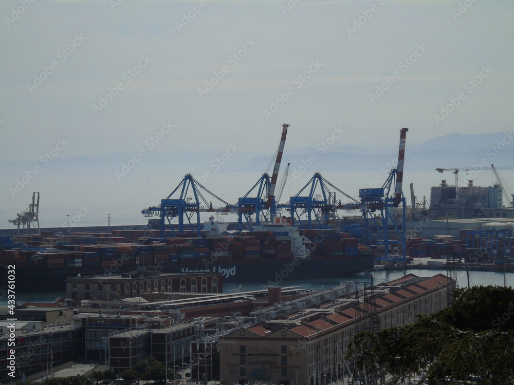 Genova, Italy - May 09, 2021: Panoramic view of the port Genoa, Italy. View from the sea to the old town, and the port on spring sunny day. Genoa bay, harbor, yacht at the pier. Tourist destinations.