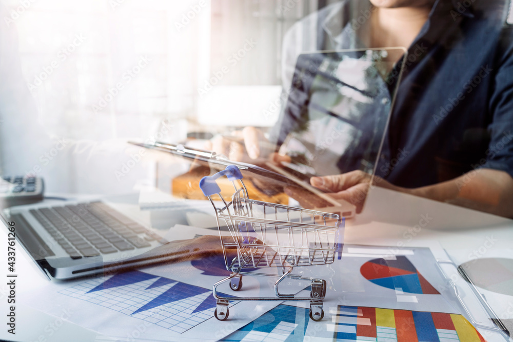 Business women reading document on office with tablet and graph financial diagram.Teamwork workplace strategy Concept. Business women reading document on office with tablet and graph financial diagram.Teamwork workplace strategy Concept.