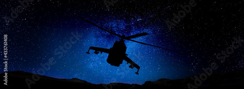 Combat helicopter in the starry sky.