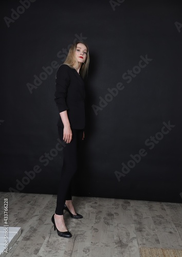 fashion girl on a black background in black clothes with red lips © Наиля Мустафина