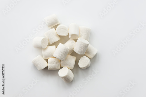 Marshmallows in a heap on a light background. Horizontal orientation, top view.