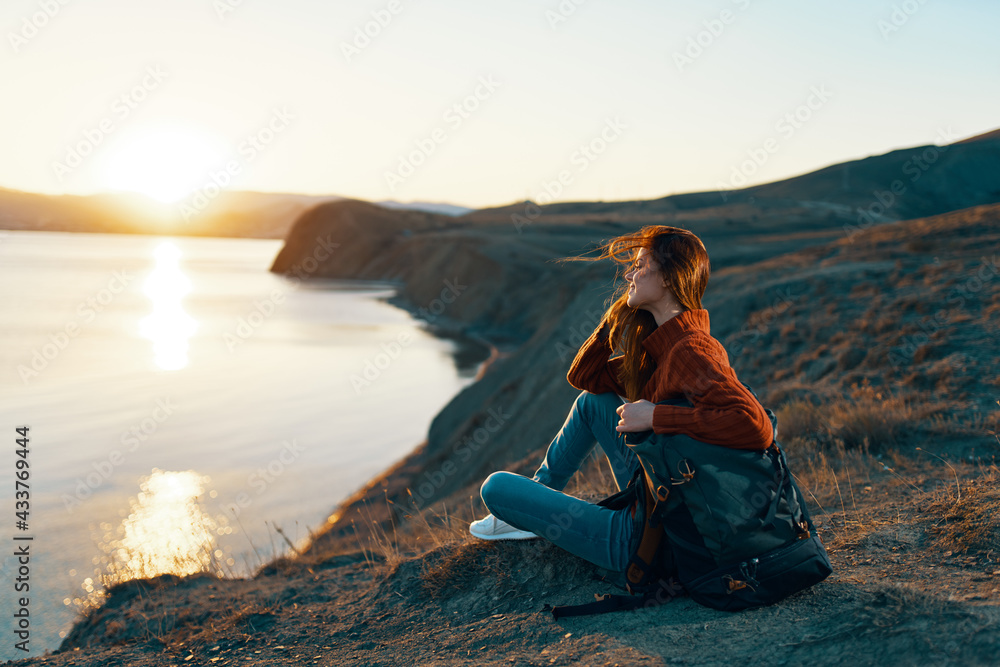 woman tourist sitting on the ground admiring nature landscape fresh air woman tourist sitting on the ground admiring nature landscape fresh air