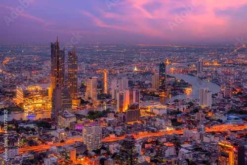 View of Bangkok cityscape. Aerial view of business modern building around the Chao Phraya river in Thailand at twilight time.