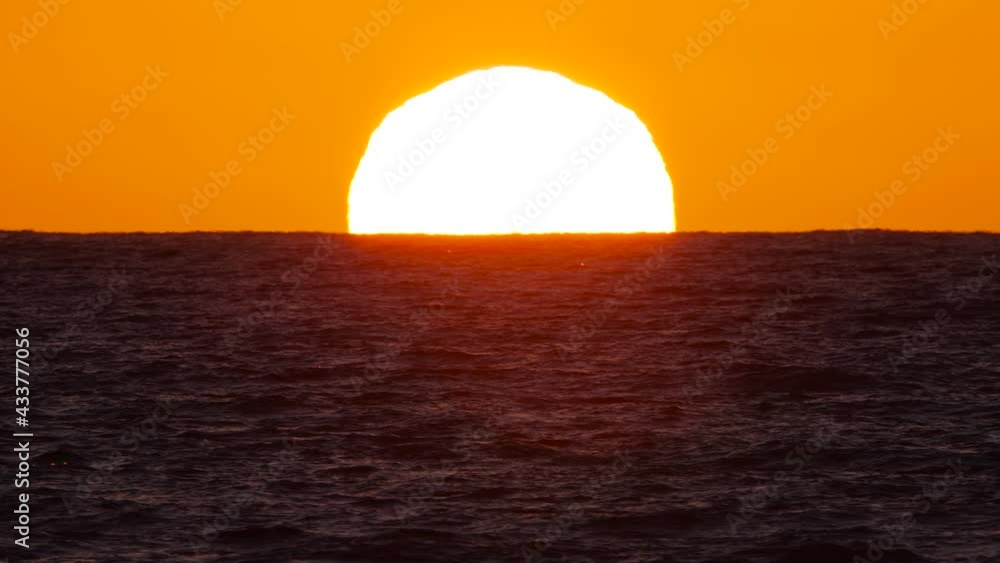 Sun over the sea, The concept of Sunset or dawn, Sunlight shines through the ocean waves Sun over the sea, The concept of Sunset or dawn, Sunlight shines through the ocean waves