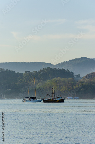 Tour boats at the pier bordering the beach in Paraty, Rio de Janeiro © Colozio