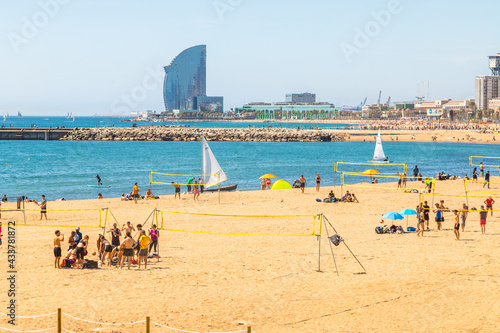 Fototapeta Naklejka Na Ścianę i Meble -  Beautiful picture of Barcelona beach plenty of people enjoying  the sun and summer playing beach sports.