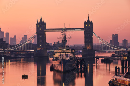 View of Tower Bridge against skyscrapers. Urban skyline of London at morning light  United Kingdom..