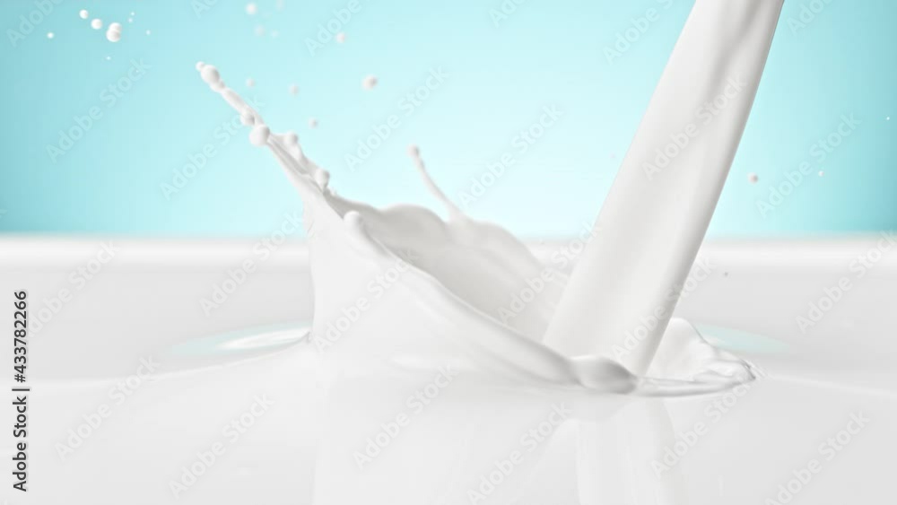 Super Slow Motion Shot of Pouring and Splashing Fresh Milk on Blue Background at 1000 fps. Super Slow Motion Shot of Pouring and Splashing Fresh Milk on Blue Background at 1000 fps.