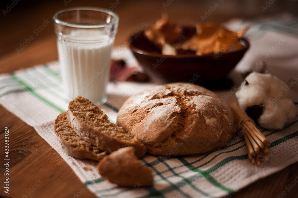 Fototapeta premium black bread with milk on brown background