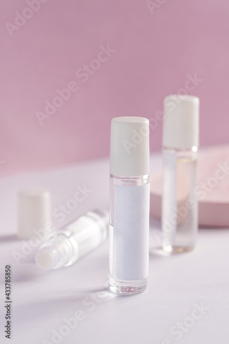 glass product package perfume samples on pink background
