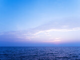 Peaceful sea scape and blue tone sunset or sunrise sky, tropical island ocean view at dawn or dusk