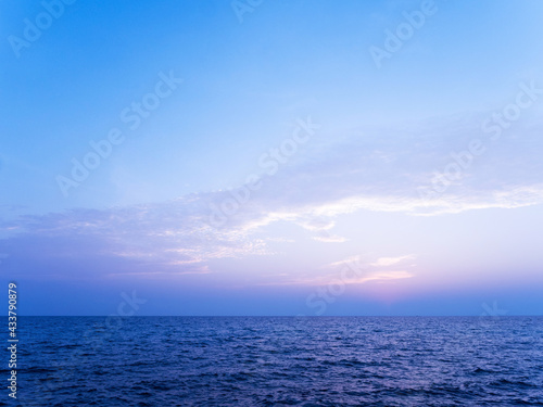 Peaceful sea scape and blue tone sunset or sunrise sky, tropical island ocean view at dawn or dusk