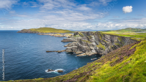 Large panorama with Kerry Cliffs and blue coloured Atlantic Ocean on a sunny summer day, Portmagee, Iveragh peninsula, Ring of Kerry, Ireland