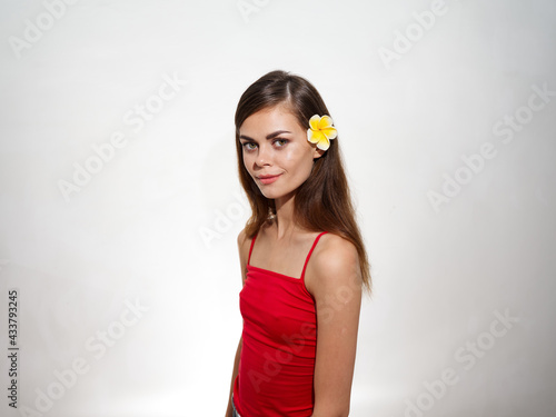 pretty woman with yellow flower in hair clean skin cosmetology model