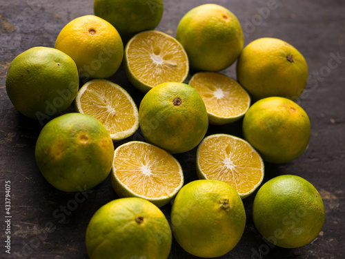 Fresh Mousambi OR Green lemon stock image on dark background. photo