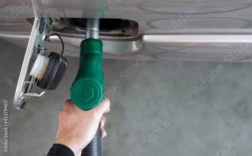 Photos Gas station worker filling up bronze pickup truck tank (Top View)