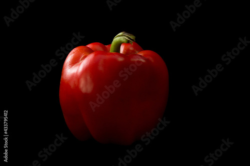 Fresh red bell pepper isolated on black background - Healty food