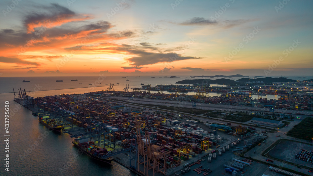 Aerial view of sunset sky at international cargo sea port.