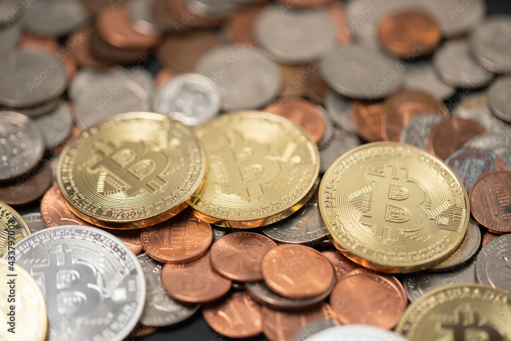 A pile of coins, US dollar coins next to Crypto coins. Gold and silver Bitcoins on top of copper pennies. Digital currency concept. trading USD with BTC A pile of coins, US dollar coins next to Crypto coins. Gold and silver Bitcoins on top of copper pennies. Digital currency concept. trading USD with BTC