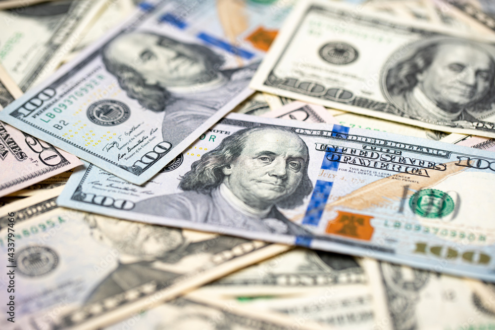Closeup of one hundred dollar banknotes, new and old paper bills from USA. American cash and money piled up Closeup of one hundred dollar banknotes, new and old paper bills from USA. American cash and money piled up